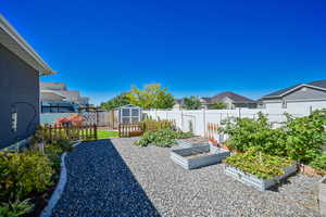 View of yard featuring a storage unit