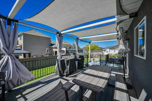 Wooden deck featuring a lawn