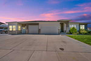 View of front of home featuring a lawn and a garage