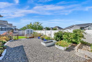 View of yard featuring a storage unit