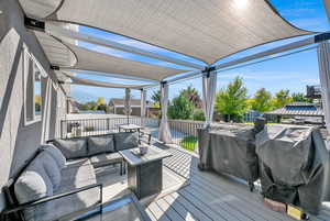 Deck with grilling area and an outdoor living space