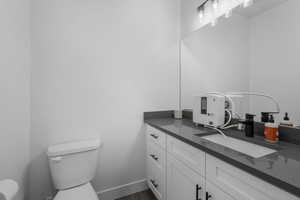 Bathroom with vanity, and toilet.