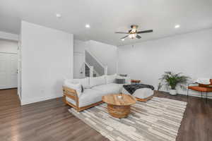 Living room featuring ceiling fan.