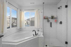 Bathroom with plenty of natural light and independent shower and bath.