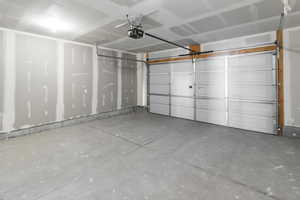 Garage featuring a garage door opener