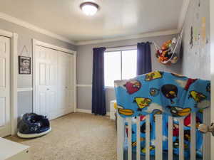 Bedroom with a closet and ornamental molding