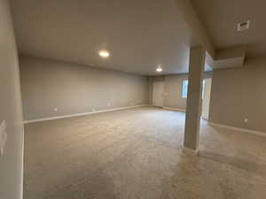 Basement with light colored carpet