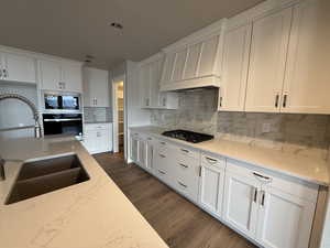 Kitchen with white cabinets, stainless steel appliances, and sink