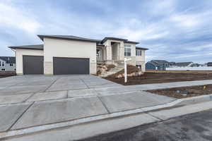 View of front facade featuring a garage