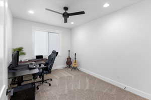 Office space featuring ceiling fan and light carpet