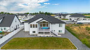 Rear view of house featuring a mountain view and a yard