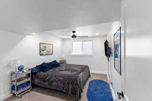 Carpeted bedroom with ceiling fan