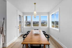 Dining room with a mountain view and light wood-type flooring