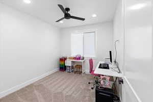 Home office featuring light colored carpet and ceiling fan