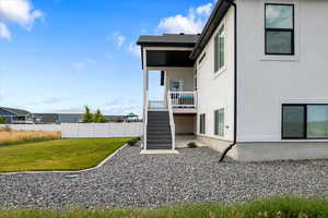 Rear view of house featuring a yard