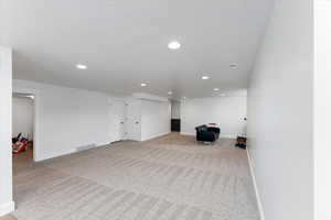 Basement featuring light carpet