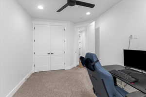 Carpeted home office with ceiling fan