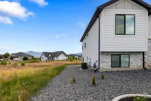 View of side of property with central AC