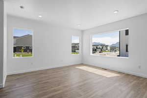 Empty room featuring hardwood / wood-style floors