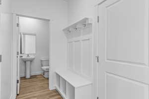 Mudroom with sink and light hardwood / wood-style flooring