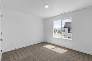 Unfurnished room with carpet