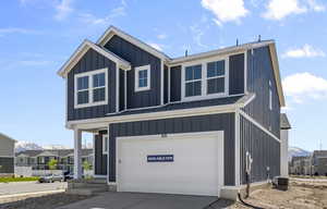 View of front of property with central AC unit and a garage