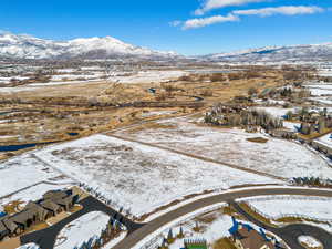 Snowy aerial view featuring a mountain view