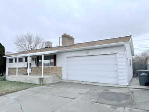 Ranch-style house featuring a garage and a porch