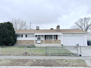 Ranch-style house featuring a garage and a porch