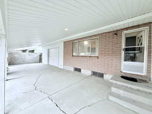 View of patio featuring a garage