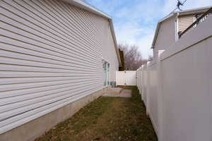 View of side of home featuring a lawn