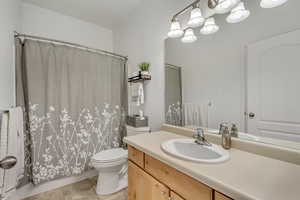 Bathroom with tile patterned flooring, vanity, and toilet