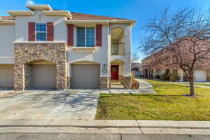 View of front of property featuring a garage and a front yard