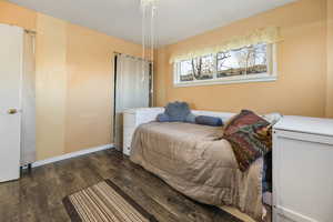 Bedroom featuring dark wood-type flooring