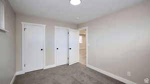 Unfurnished bedroom featuring carpet flooring and a textured ceiling