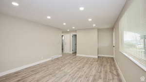 Unfurnished room with light hardwood / wood-style flooring