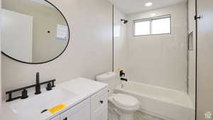 Full bathroom featuring shower / washtub combination, vanity, and toilet