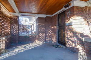 Front porch with wisteria vines.