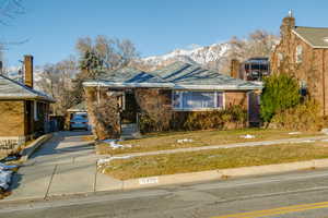 Bungalow-style house with a mountain view and a front yard