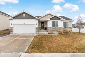 Craftsman-style house with central AC unit, a garage, and a front lawn