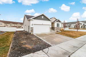 View of front of home featuring a front yard and a garage