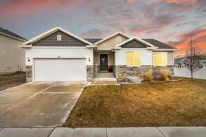 Craftsman-style house featuring a yard, a garage, and cooling unit