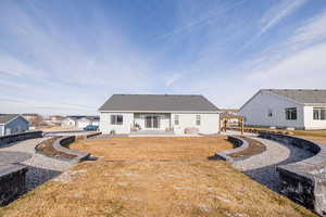 Back of property with a gazebo and a yard