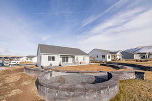 Rear view of house with a fire pit area