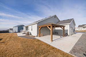 Rear view of property with a gazebo, a patio, cooling unit, and a lawn