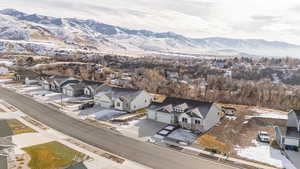 Snowy aerial view featuring a mountain view