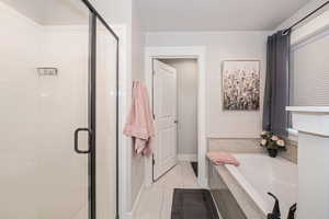 Bathroom with tile patterned floors and plus walk in shower