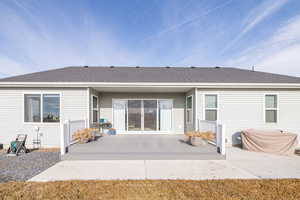 Rear view of property with a partially covered  patio with Trex decking