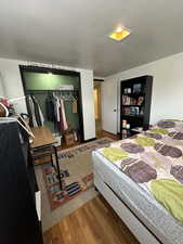 Bedroom featuring hardwood / wood-style floors and a closet