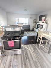 Kitchen with light hardwood / wood-style floors and double oven range